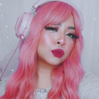 portrait of highxlash in pink wig, pink headphones. white backdrop